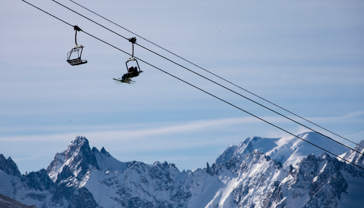 A ski lift over jagged mountains